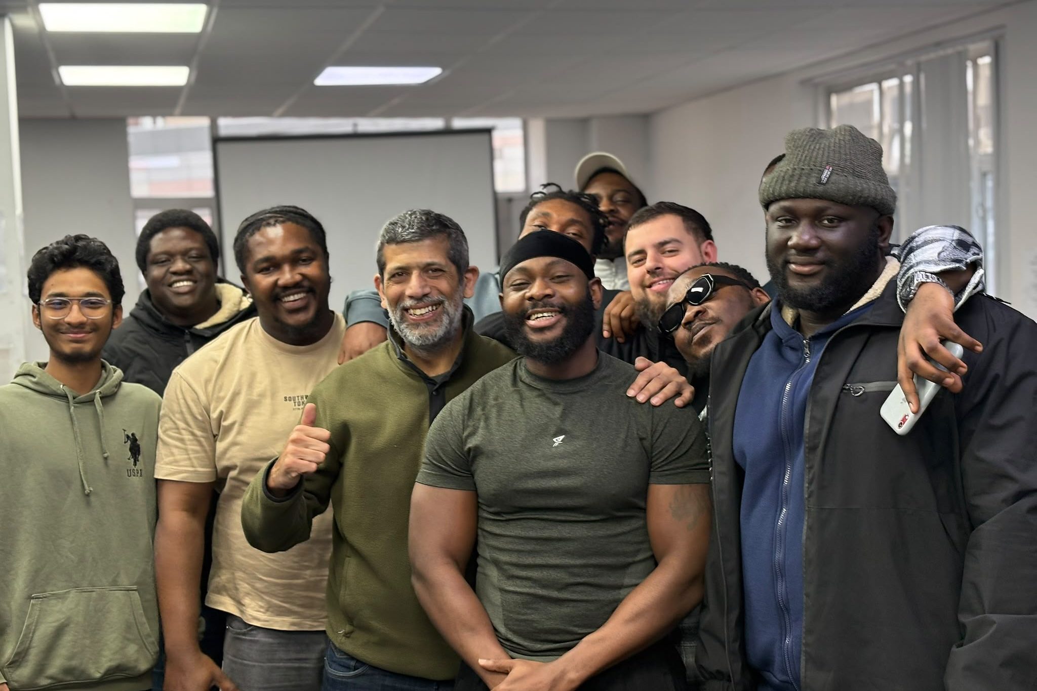 Learners and their trainer celebrating at the end of a course.